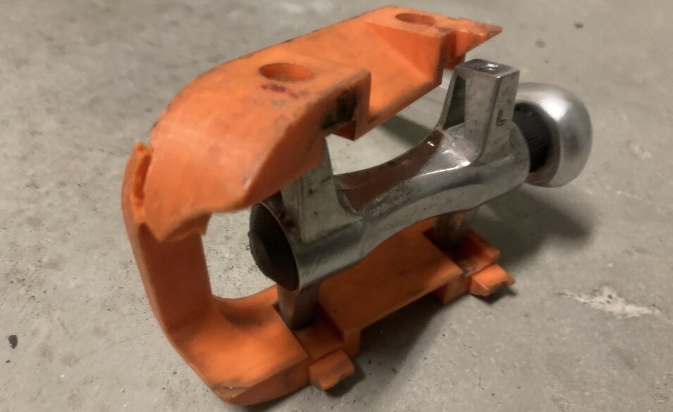Cracked orange plastic foot pad. Metal bearing in center. Back half of pedal mounted correctly, Front half of pedal broken loose