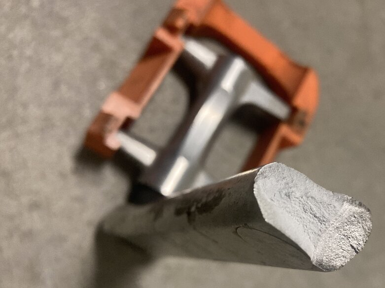 Broken bicycle pedal. Cracked orange plastic part in background. Close up of crack