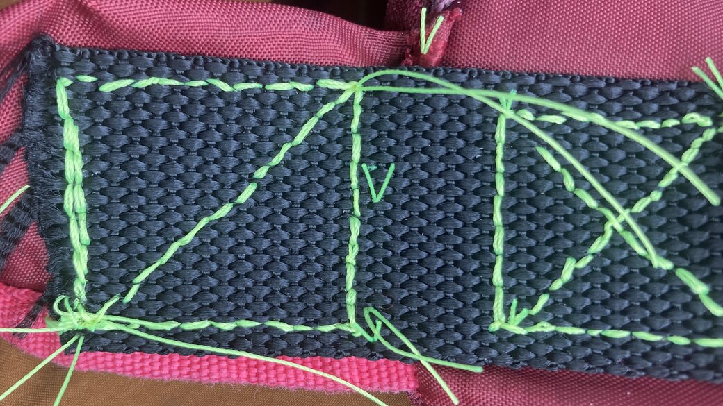In progress stitching showing part of the (incorrectly woven) figure eight pattern for stitching to the strap with about half completed